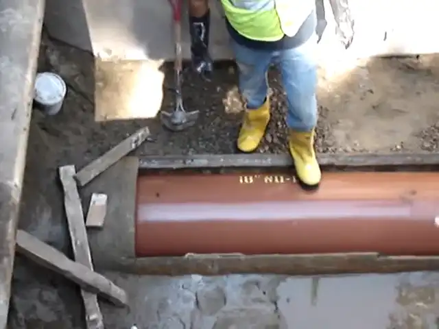 pulling new clay pipe through an opening