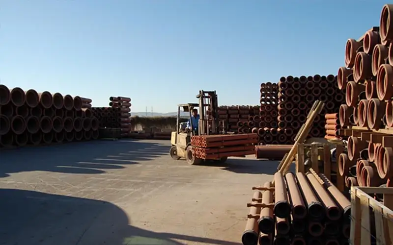forklift with clay pipe being transported