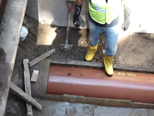 pulling new clay pipe through an opening